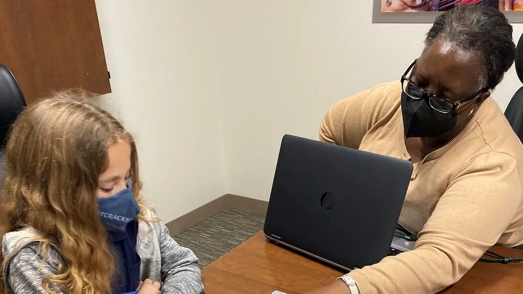 A student using a laptop donated to the Buckner Family Hope Center